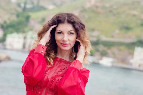 Young woman in a red dress posing — Stock Photo, Image