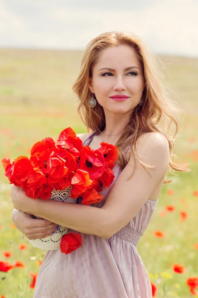 Young woman with long hair in poppies — Stock Photo, Image