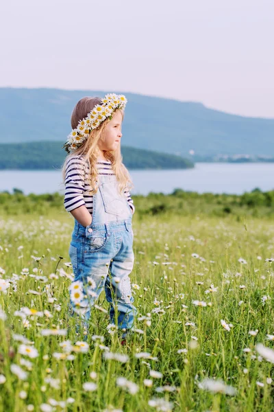 Happy little girl in the romomile field — стоковое фото