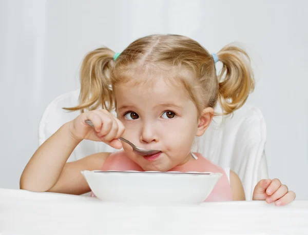 Boldog kislány eszik kanállal — Stock Fotó