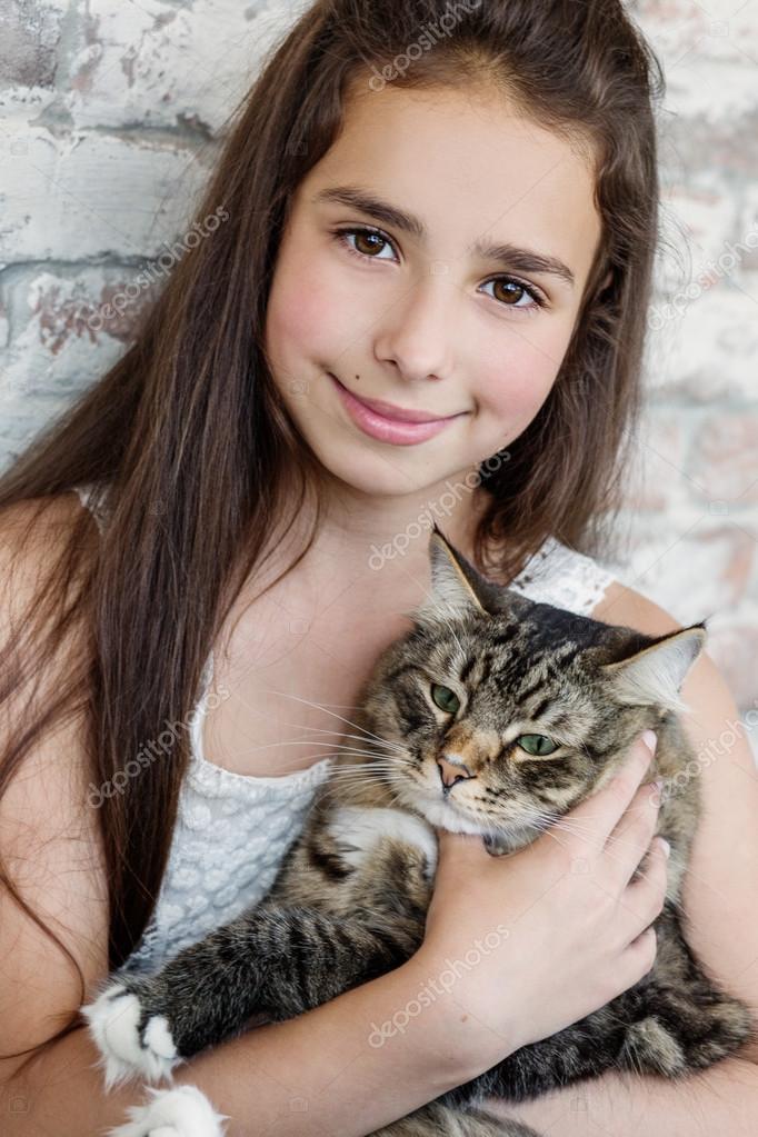 Pretty girl teenager 10-11 years holding a cat Stock Photo by ©marchibas  113743646