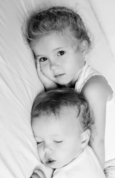 charming little brother and sister asleep