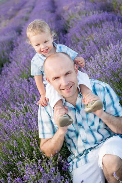 Happy dad with baby son in lavender — Stock Photo, Image