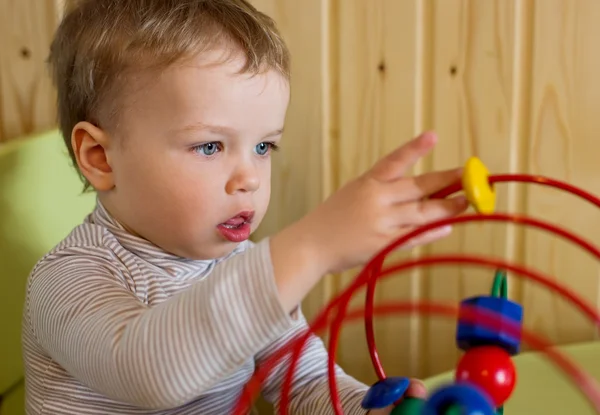 Toddler boy playing with educational toys — Stock Photo, Image