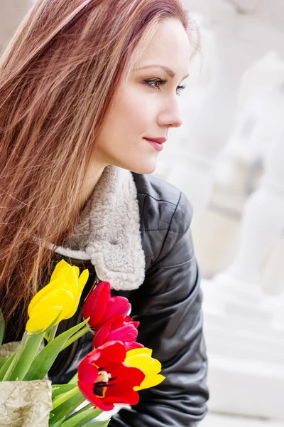 Beautiful happy woman with tulips — Stock Photo, Image