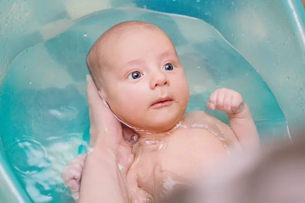 Cute newborn bathes in a bathroom — Stock Photo, Image