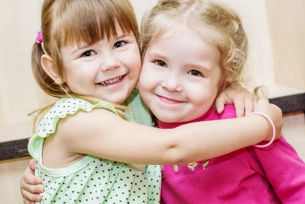 Two happy little girls hugging — Stock Photo, Image