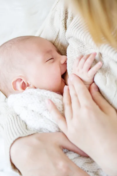 Мать кормит грудью новорожденного, улыбаясь — стоковое фото