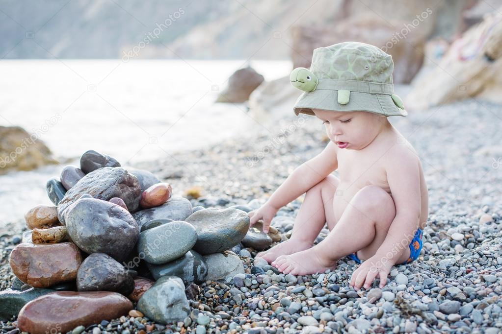 cute toddler on the beach playing 