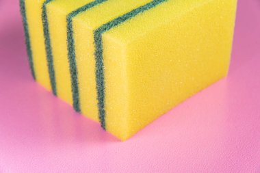 Pembe arka planda mutfak süngeri.
