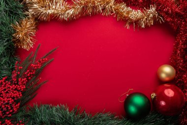 Canlı kırmızı arkaplanda şenlikli noel dekorasyonu