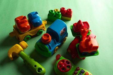 Colorful toys on a green background