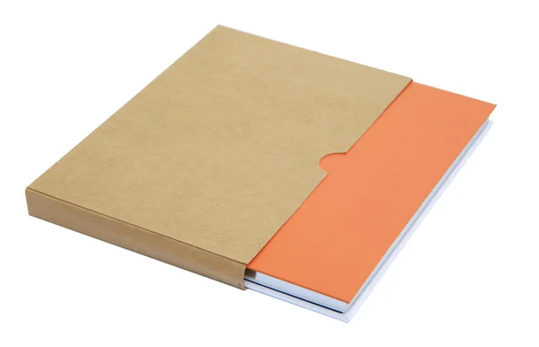 Orange notebook i brunt papper fall isolerat på vit bakgrund — Stockfoto