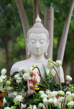 Çiçekler ve Tayland Magha Puja, Asalha Puja ve Visakha Puja gün buddha heykeli Garland'a sunan ile Budizm ibadet