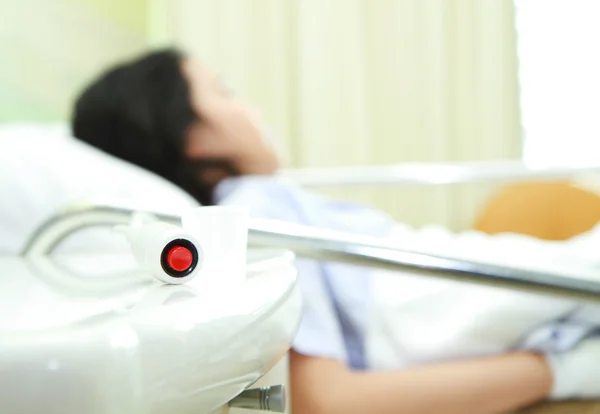 Arka planda basarak acil hemşire çağrı düğmesine ve hasta el