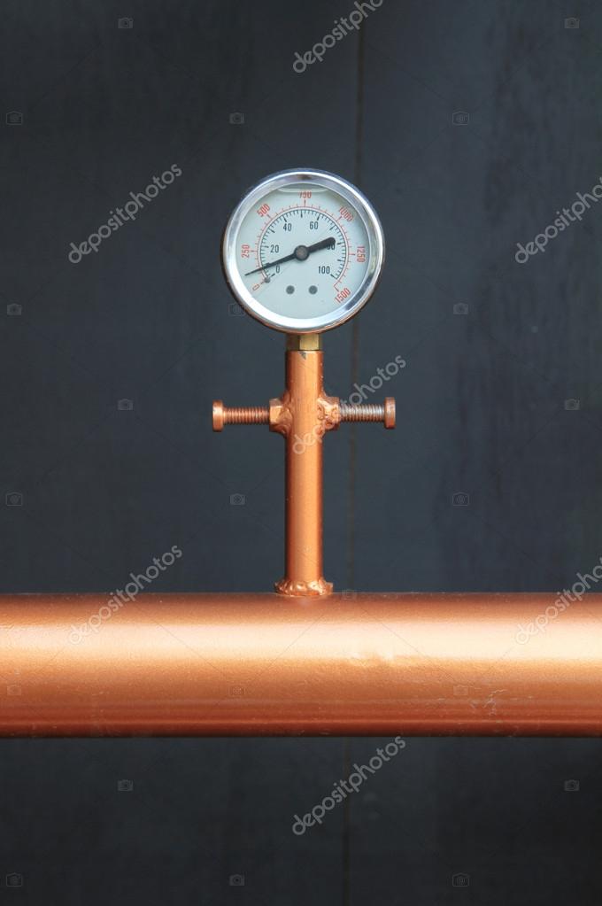 Pressure gauge meter installed on copper pipes Stock Photo by ©drpnncpp