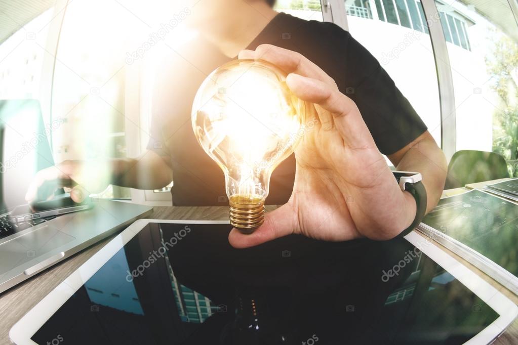 designer hand showing creative business strategy with light bulb