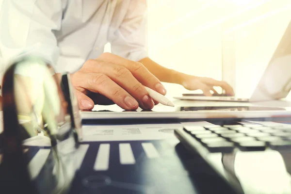 Business documents on office table with laptop computer and grap — Stock Photo, Image