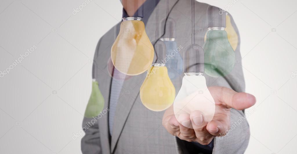 Double exposure of Businessman hand working with 3d light bulb o