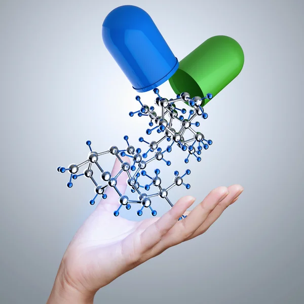 Hand with capsule pill and molecule as medical concept — Stock Photo, Image