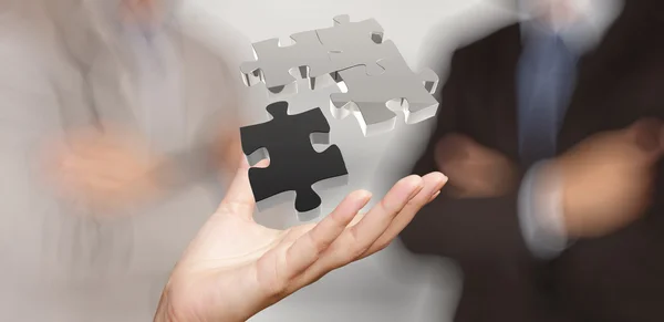 Üzletember kéz mutatja 3D puzzle partnerségi jel koncepció — Stock Fotó