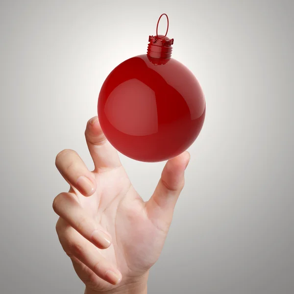 Hand showing Christmas ornament — Stock Photo, Image