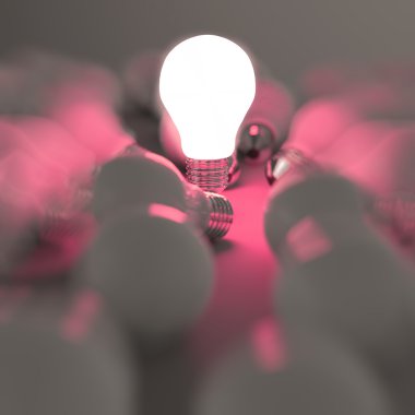 growing light bulb standing out from the unlit incandescent bulb clipart