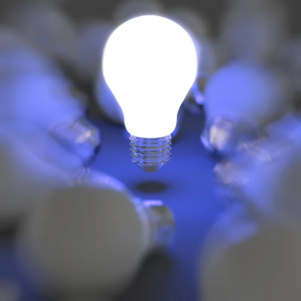 Growing light bulb standing out from the unlit incandescent bulb