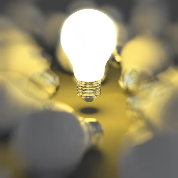 Growing light bulb standing out from the unlit incandescent bulb