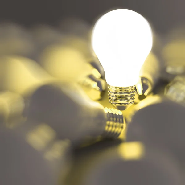 Growing light bulb standing out from the unlit incandescent bulb — Stock Photo, Image