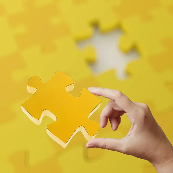 Female hand placing last piece of Puzzle as concept — Stock Photo, Image