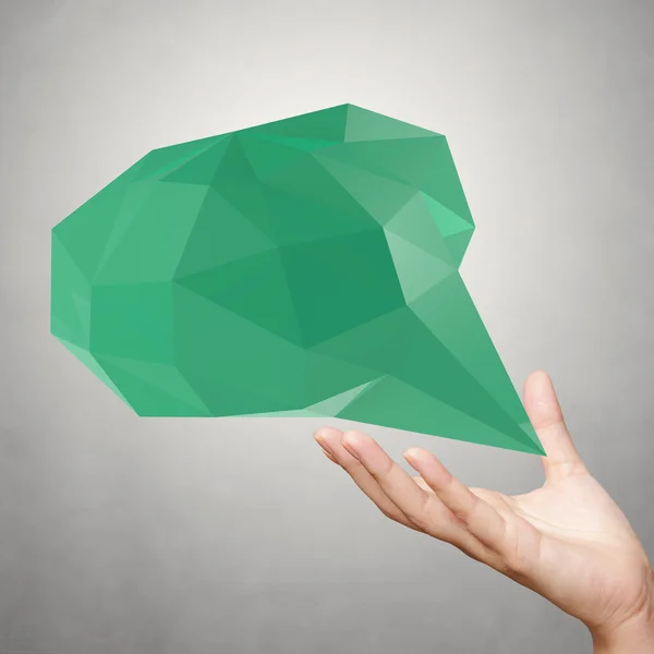 Hand showing low poly geometric speech bubble on white backgroun — Stock Photo, Image