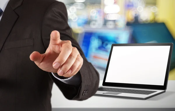 Businessman and blank laptop computer in shop background as conc — Stock Photo, Image