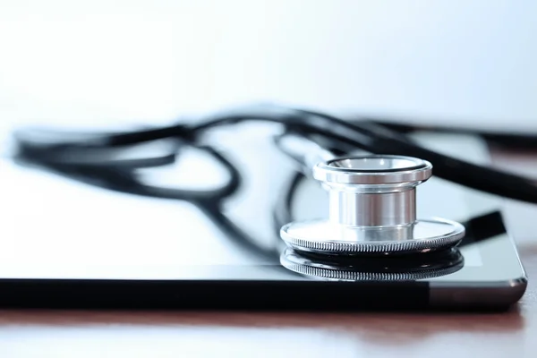 Stethoscope on wooden table and  background
