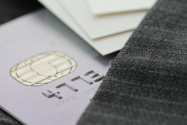 Credit cards in very shallow focus  with gray suit background clipart
