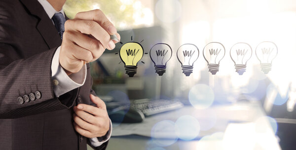 hand drawing creative business strategy with light bulb as conce