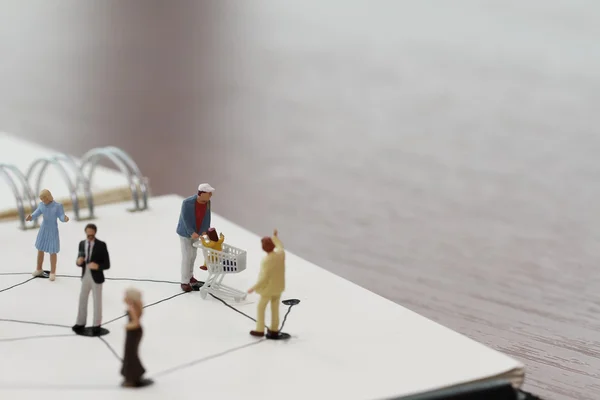 Primo piano di persone in miniatura con diagramma di social network aperto — Foto Stock