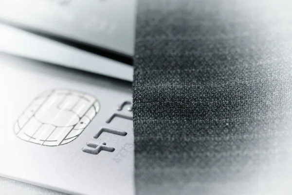 Credit cards in very shallow focus with gray suit background as — Stock Photo, Image