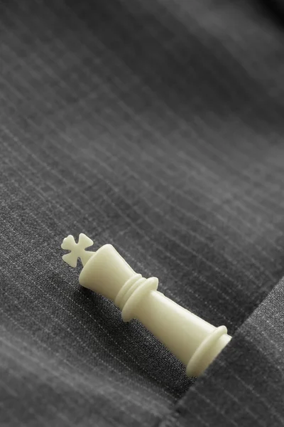 Close up of chess figure on suit background strategy or leadersh — Stock Photo, Image