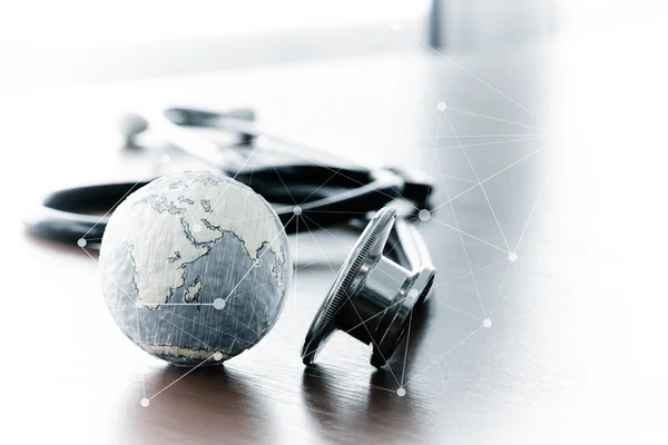 Studio macro of a stethoscope and texture globe with shallow DOF — Stock Photo, Image