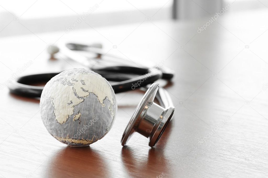 Studio macro of a stethoscope and texture globe with shallow DOF