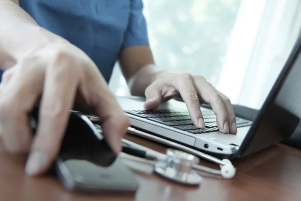 Doctor working with laptop computer in medical workspace office