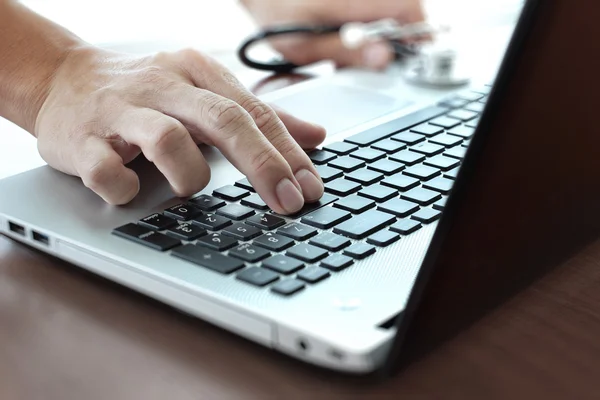 Gros plan de la main du médecin en utilisant un ordinateur portable dans le bureau — Photo