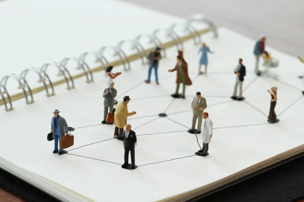 Närbild av miniatyr människor med sociala nätverk diagram på öppen — Stockfoto