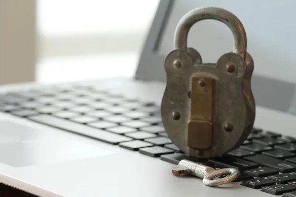 Internet security concept-old padlock and key on laptop computer — Stock Photo, Image