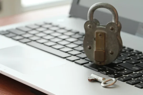 Internet security concept-old padlock and key on laptop computer — Stock Photo, Image