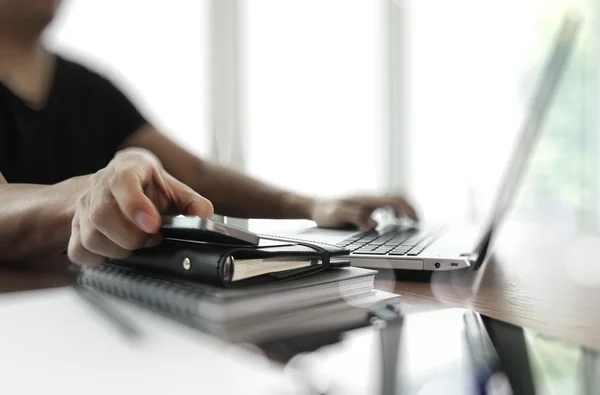 Businessman hand using laptop and mobile phone in office — Stock Photo, Image