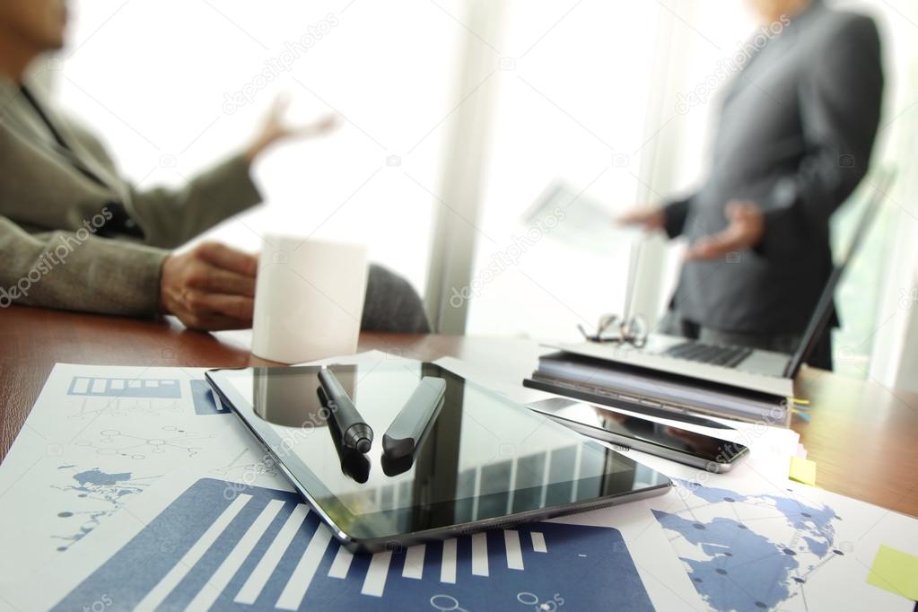 business documents on office table with smart phone and digital 