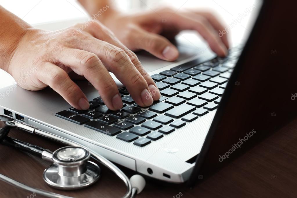 Doctor working with laptop computer in medical workspace office 