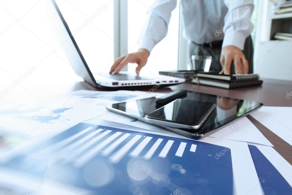 business documents on office table with smart phone and digital 